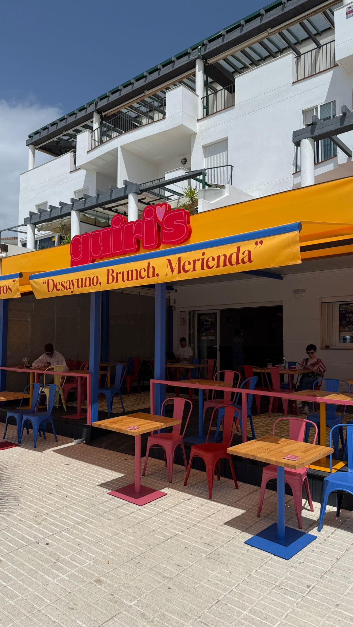 Fachada de Guiri's en el Paseo Marítimo de Barbate, con toldo amarillo: Desayuno, Brunch, Merienda